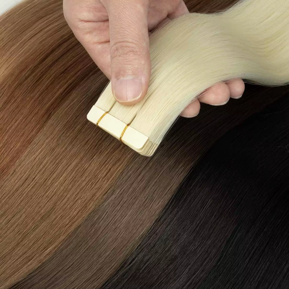 Extensions de cheveux synthétiques à bandes adhésives