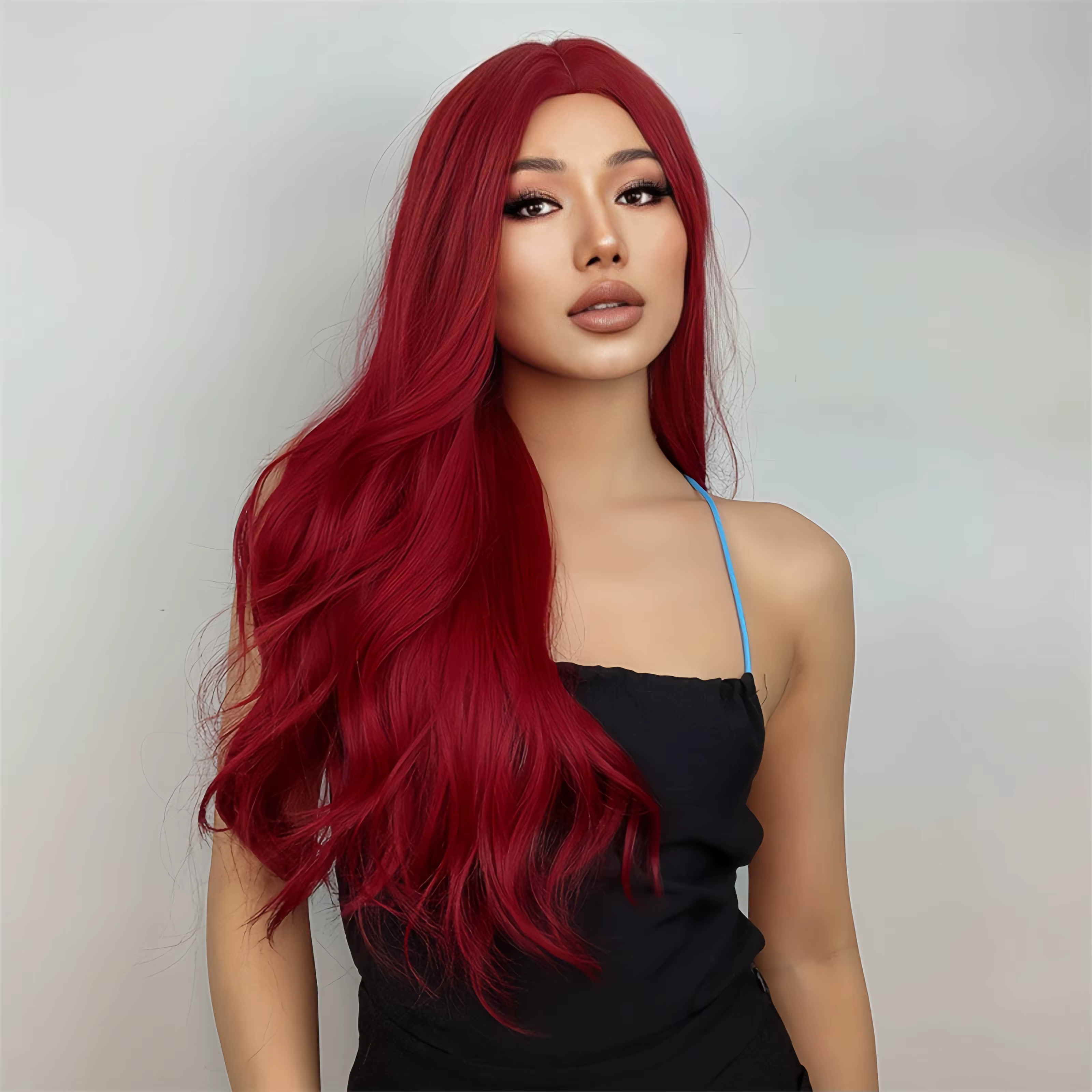 Perruque synthétique rouge avec partie centrale et cheveux longs ondulés. Convient aux fêtes quotidiennes et aux temps